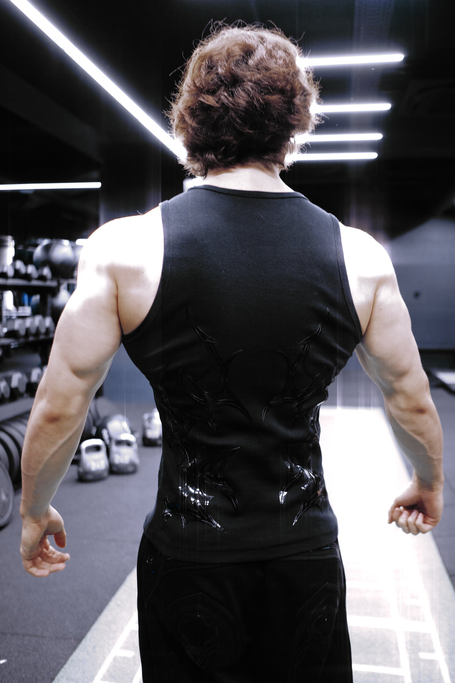 Fallen Tank Midnight, back view in the gym with the silicone motif